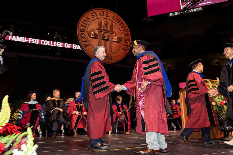 Florida State University President Richard McCullough congratulates a graduate during the fall 2025 commencement ceremony, held Friday, Dec. 12, 2025, at the Donald L. Tucker Civic Center. (Bill Lax/ Florida State University)