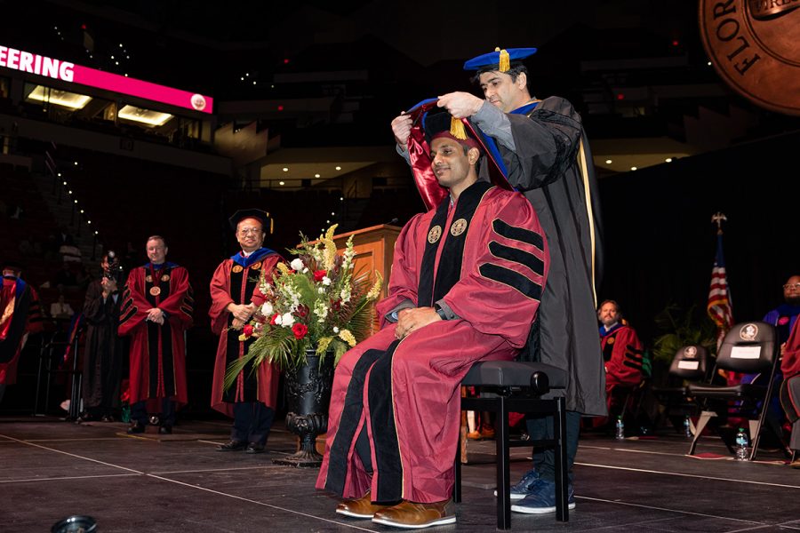 A Florida State University faculty member hoods a graduate during the summer doctoral hooding ceremony, Friday, Dec. 12, 2025, at the Donald L. Tucker Civic Center. (Bill Lax/ Florida State University)