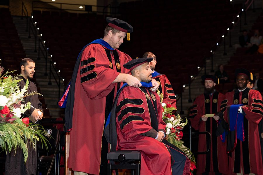 A Florida State University faculty member hoods a graduate during the summer doctoral hooding ceremony, Friday, Dec. 12, 2025, at the Donald L. Tucker Civic Center. (Bill Lax/ Florida State University)