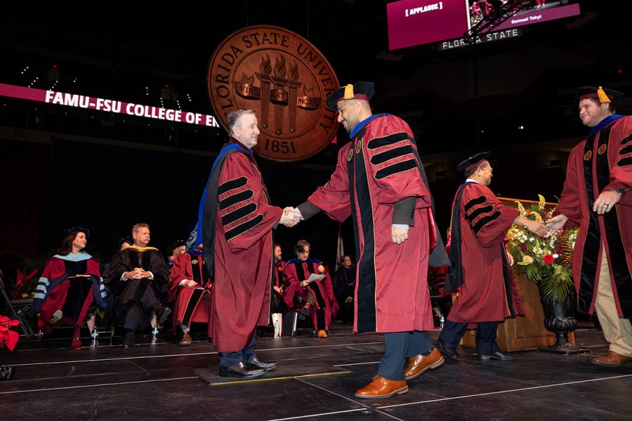 Florida State University President Richard McCullough congratulates a graduate during the fall 2025 commencement ceremony, held Friday, Dec. 12, 2025, at the Donald L. Tucker Civic Center. (Bill Lax/ Florida State University)