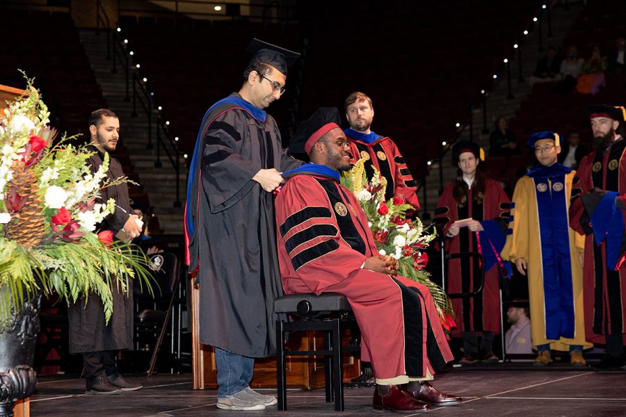 A Florida State University faculty member hoods a graduate during the summer doctoral hooding ceremony, Friday, Dec. 12, 2025, at the Donald L. Tucker Civic Center. (Bill Lax/ Florida State University)