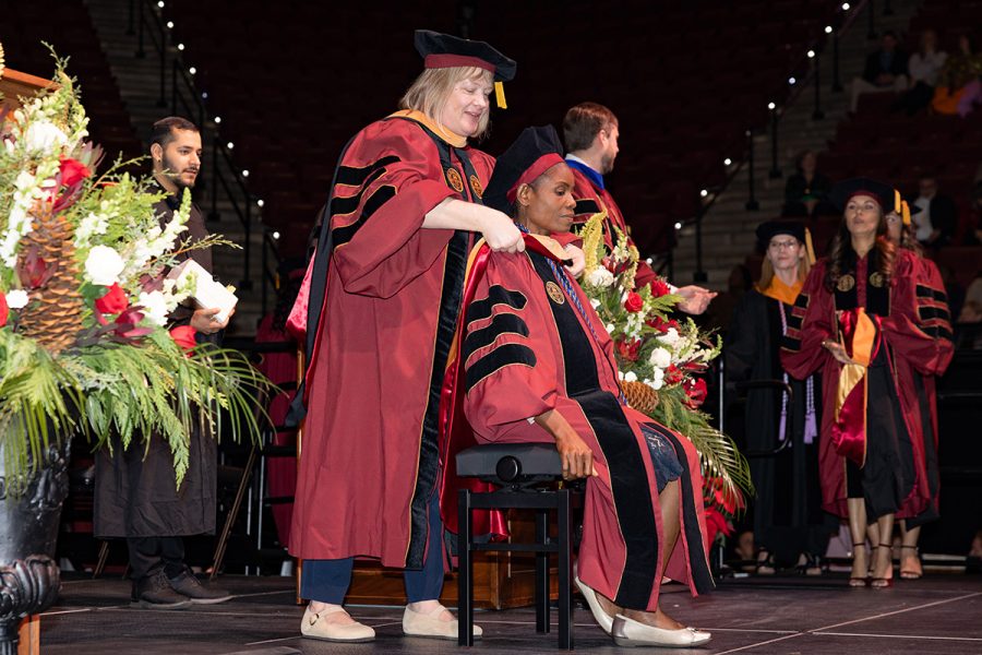 A Florida State University faculty member hoods a graduate during the summer doctoral hooding ceremony, Friday, Dec. 12, 2025, at the Donald L. Tucker Civic Center. (Bill Lax/ Florida State University)