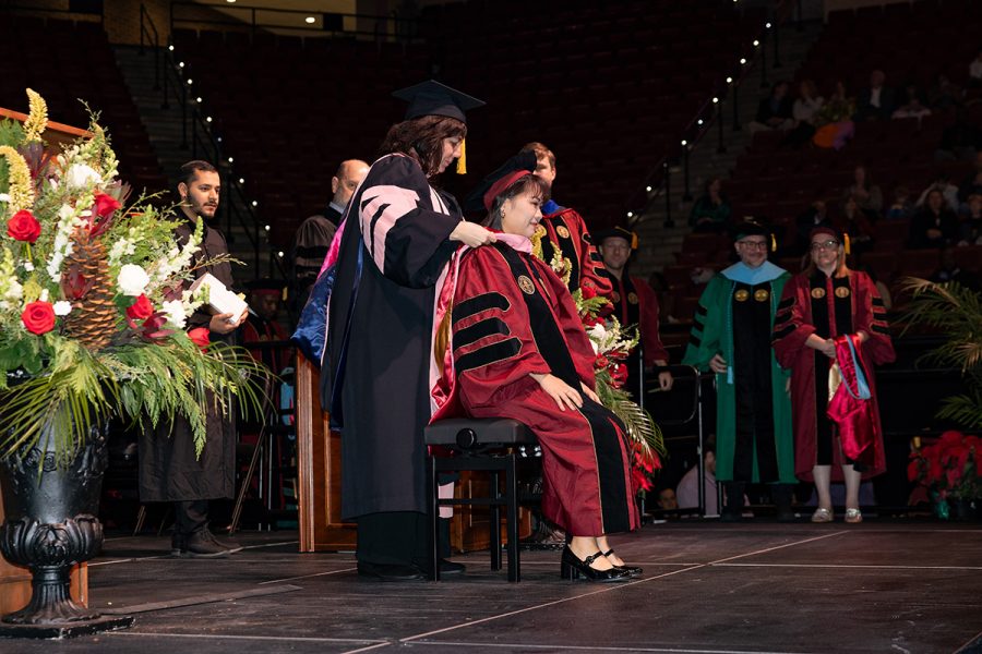 A Florida State University faculty member hoods a graduate during the summer doctoral hooding ceremony, Friday, Dec. 12, 2025, at the Donald L. Tucker Civic Center. (Bill Lax/ Florida State University)