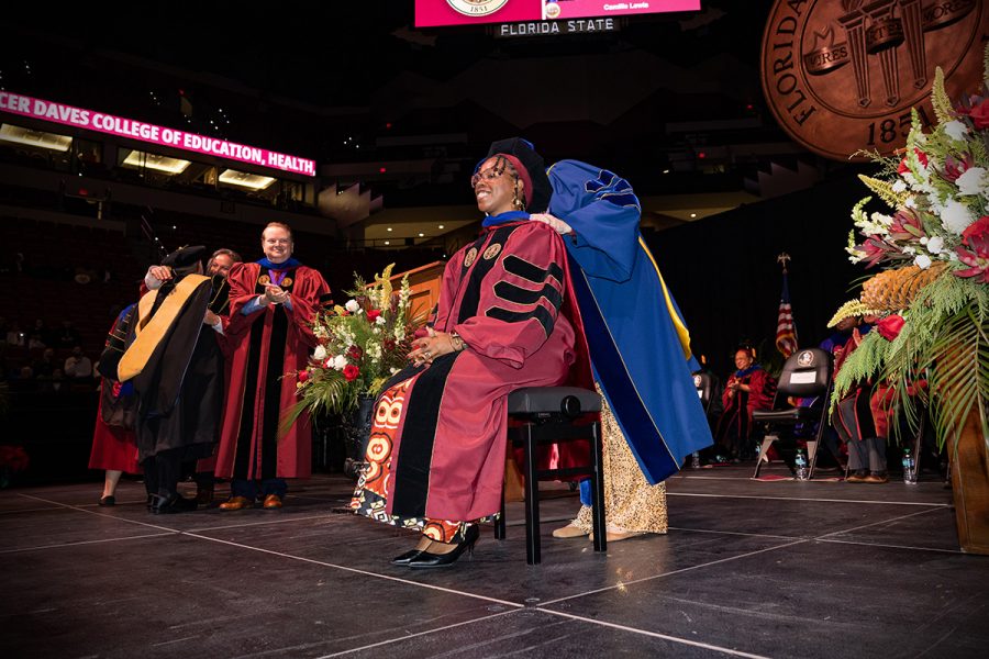 A Florida State University faculty member hoods a graduate during the summer doctoral hooding ceremony, Friday, Dec. 12, 2025, at the Donald L. Tucker Civic Center. (Bill Lax/ Florida State University)