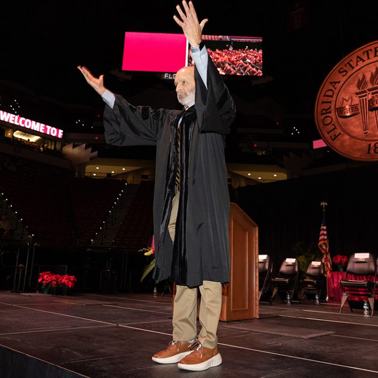 Mark Zeigler, teaching professor in the School of Communication celebrates with graduates during fall commencement Friday, Dec. 12, 2025, at the Donald L. Tucker Civic Center. (Bill Lax/ Florida State University)