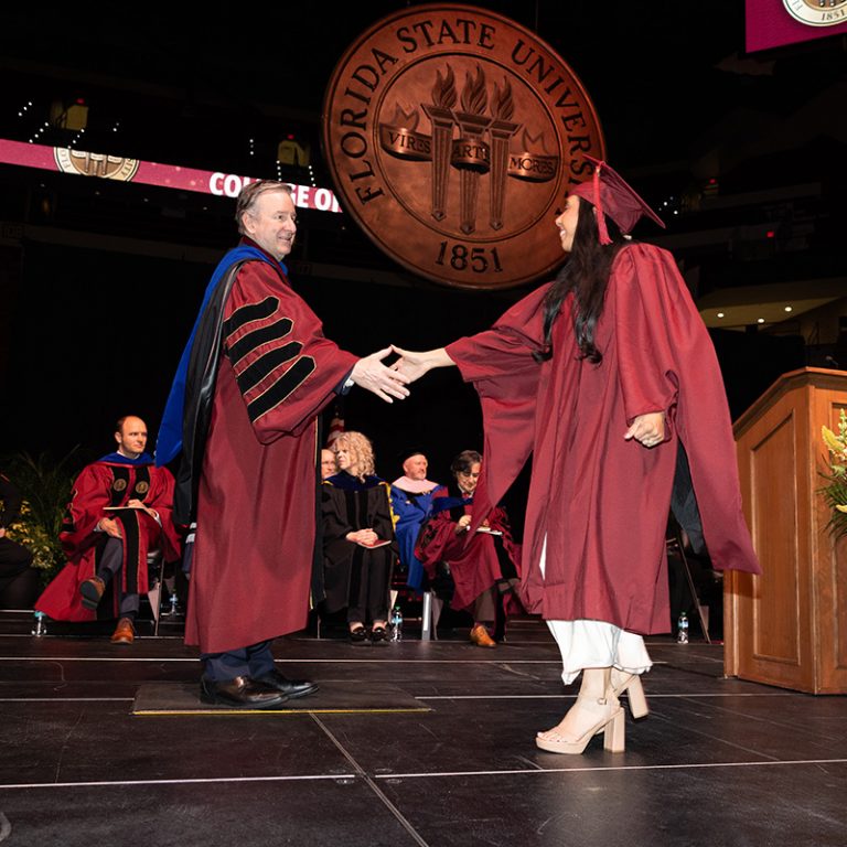 Florida State University President Richard McCullough congratulates a graduate during the fall 2025 commencement ceremony, held Friday, Dec. 12, 2025, at the Donald L. Tucker Civic Center. (Bill Lax/ Florida State University)