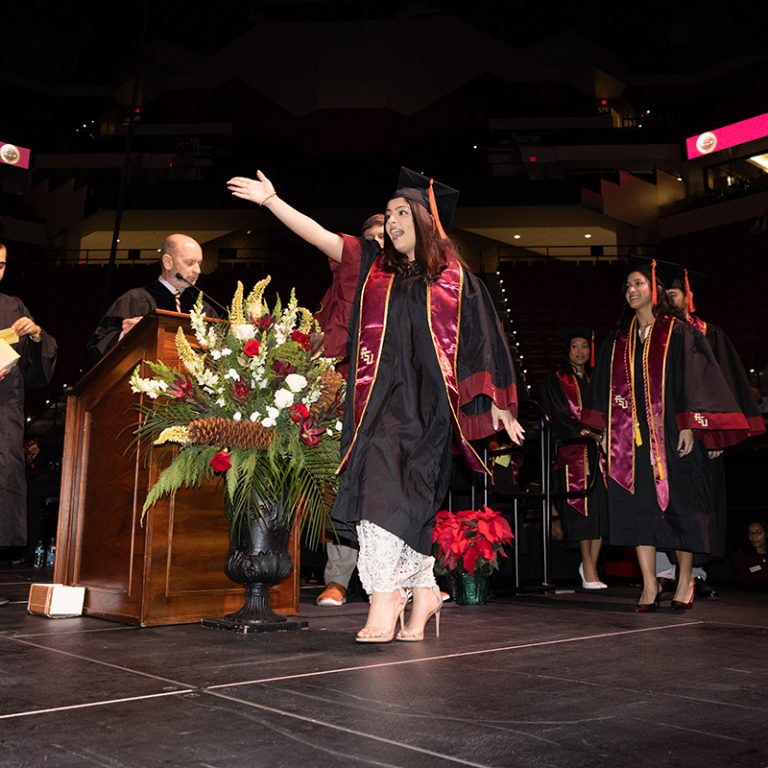 A graduate walks across the stage during Florida State University’s fall 2025 commencement ceremony, held Friday, Dec. 12, 2025, at the Donald L. Tucker Civic Center. (Bill Lax/ Florida State University)