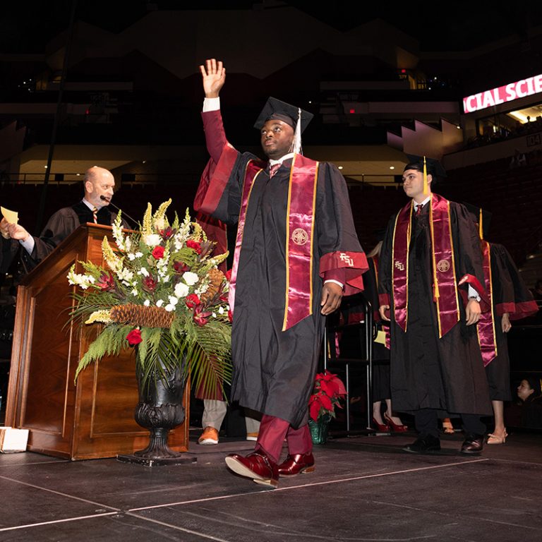 A graduate walks across the stage during Florida State University’s fall 2025 commencement ceremony, held Friday, Dec. 12, 2025, at the Donald L. Tucker Civic Center. (Bill Lax/ Florida State University)