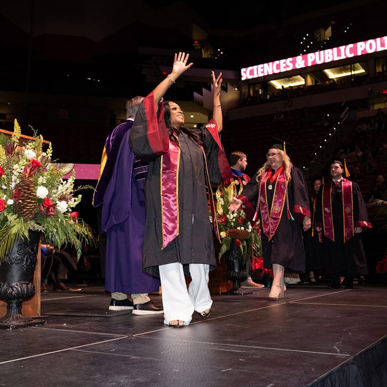 A graduate walks across the stage during Florida State University’s fall 2025 commencement ceremony, held Friday, Dec. 12, 2025, at the Donald L. Tucker Civic Center. (Bill Lax/ Florida State University)