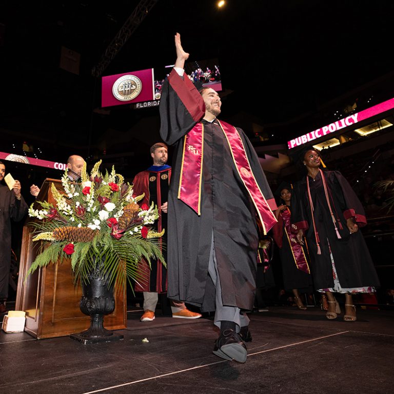 A graduate walks across the stage during Florida State University’s fall 2025 commencement ceremony, held Friday, Dec. 12, 2025, at the Donald L. Tucker Civic Center. (Bill Lax/ Florida State University)