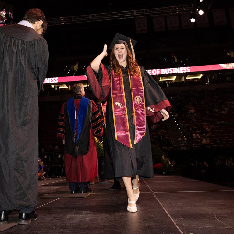 A graduate walks across the stage during Florida State University’s fall 2025 commencement ceremony, held Friday, Dec. 12, 2025, at the Donald L. Tucker Civic Center. (Bill Lax/ Florida State University)