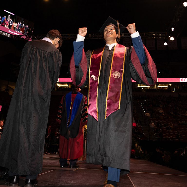 A graduate walks across the stage during Florida State University’s fall 2025 commencement ceremony, held Friday, Dec. 12, 2025, at the Donald L. Tucker Civic Center. (Bill Lax/ Florida State University)