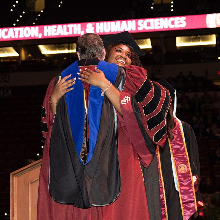 A graduate walks across the stage during Florida State University’s fall 2025 commencement ceremony, held Friday, Dec. 12, 2025, at the Donald L. Tucker Civic Center. (Bill Lax/ Florida State University)