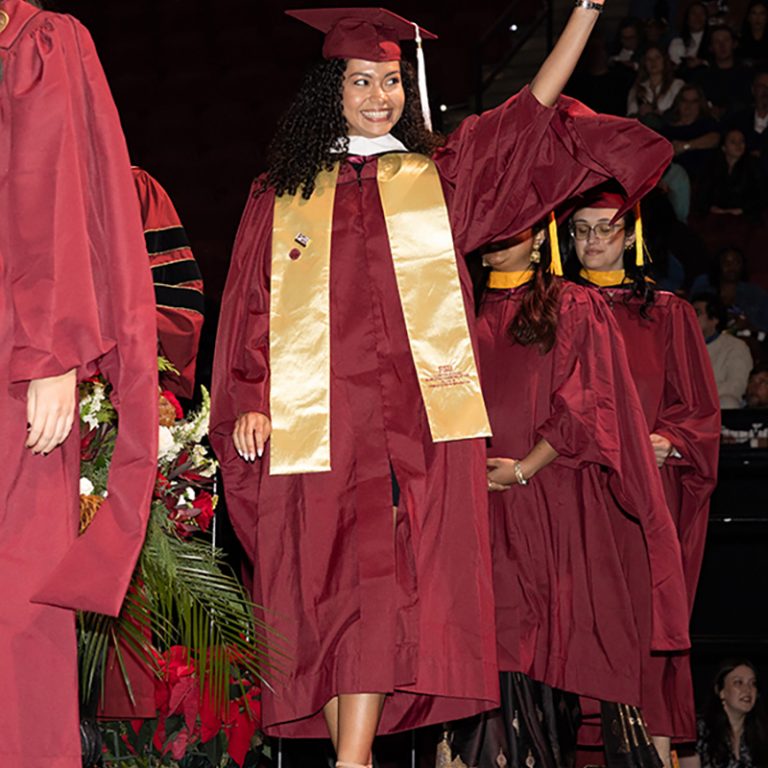 A graduate walks across the stage during Florida State University’s fall 2025 commencement ceremony, held Friday, Dec. 12, 2025, at the Donald L. Tucker Civic Center. (Bill Lax/ Florida State University)