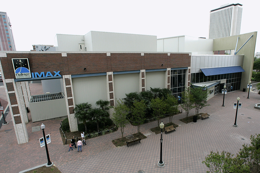 A two-story building with a brick and glass facade.