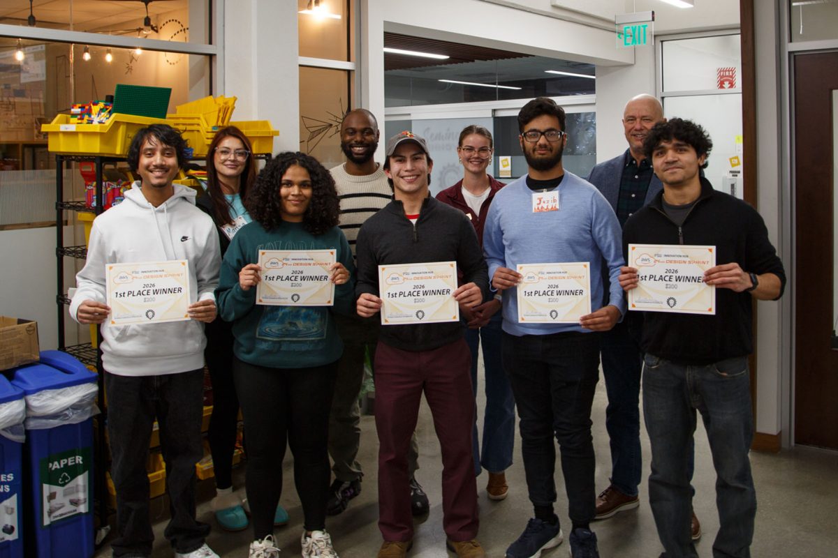 Five students holding certificates, stand in front of a panel of four judges.