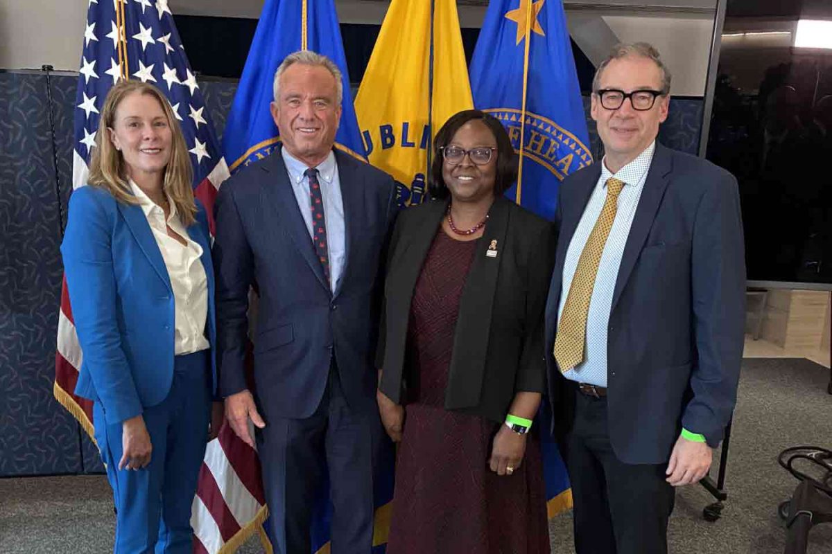 At an event promoting medical school nutrition education, four officials stand side-by-side. From left: Regan Bailey, Robert F. Kennedy, Alma Littles, and Patrick Stover.