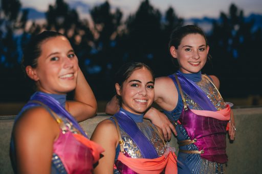 Three female FSU circus performers smile in costume