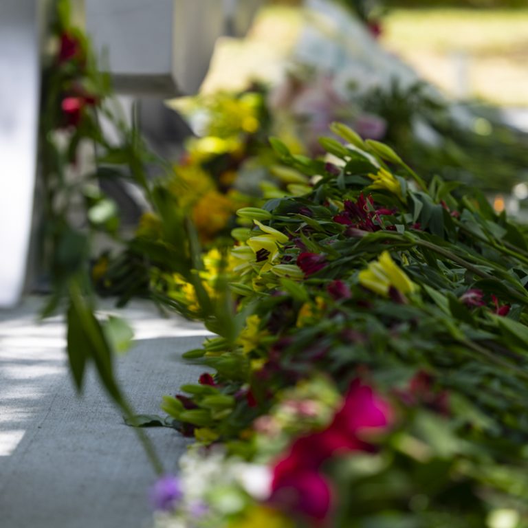 Flowers laid out in front of the FSU letters outside the student union