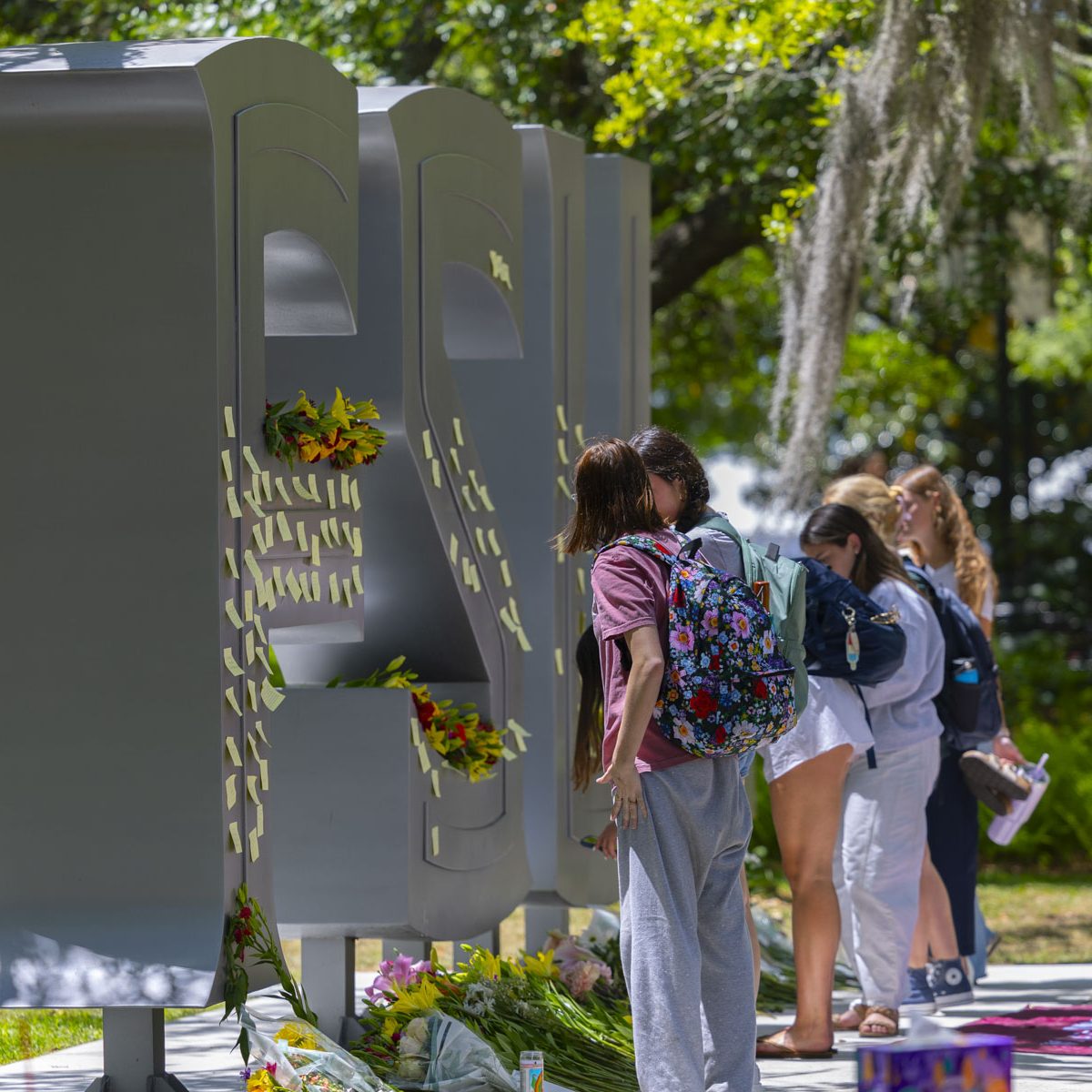 Students stand the fsu letters outside of the student union