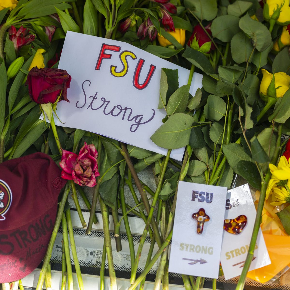 Flowers and a note stating "fsu strong" are placed on and in front of the FSU letters by the student union.