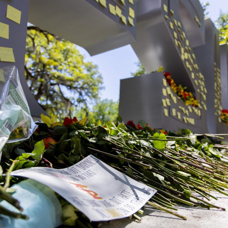 Flowers and notes are placed on and in front of the FSU letters by the student union.