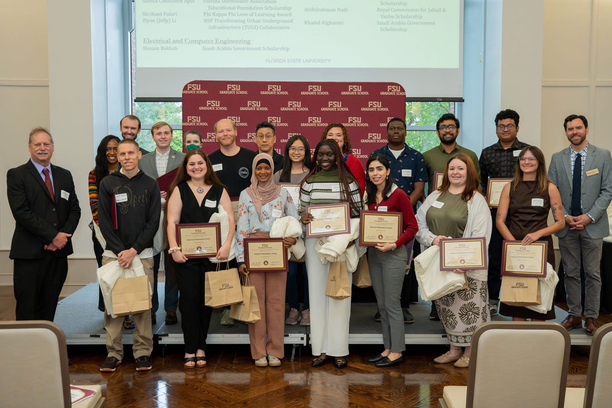 A group of FSU graduate students pose with awards