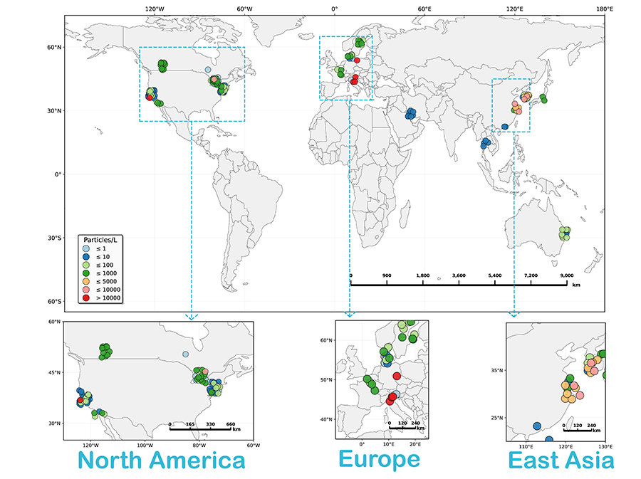 World map showing monitoring sites marked by colored circles indicating particle concentration levels. Inset maps provide close-up views of North America, Europe, and East Asia, where clusters of sites are concentrated. Circle colors represent increasing particle counts per liter, from blue (lowest) to red (highest), with a legend shown in the lower left.