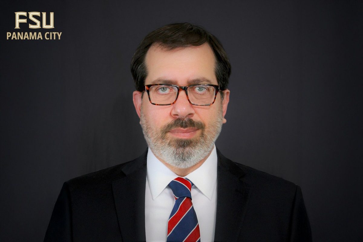 Headshot of Korhan Adalier with FSU PC logo in the corner.