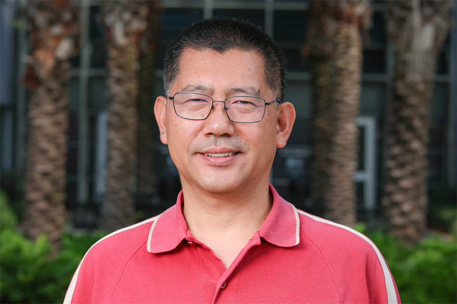 A photo portrait of Ming Ye, a professor in the Department of Earth, Ocean and Atmospheric Science.