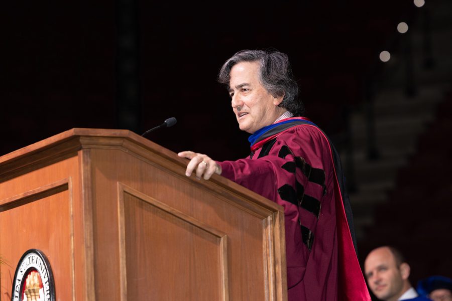 Florida State University Provost and Executive Vice President Jim Clark speaks from a podium at a commencement ceremony.