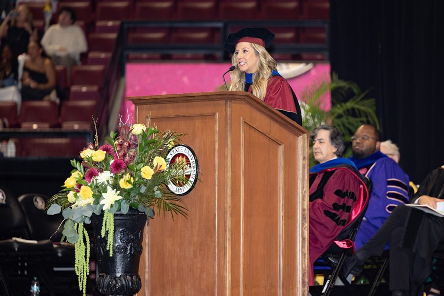 Sara Blakely looks out over the graduating class while speaking from the stage.