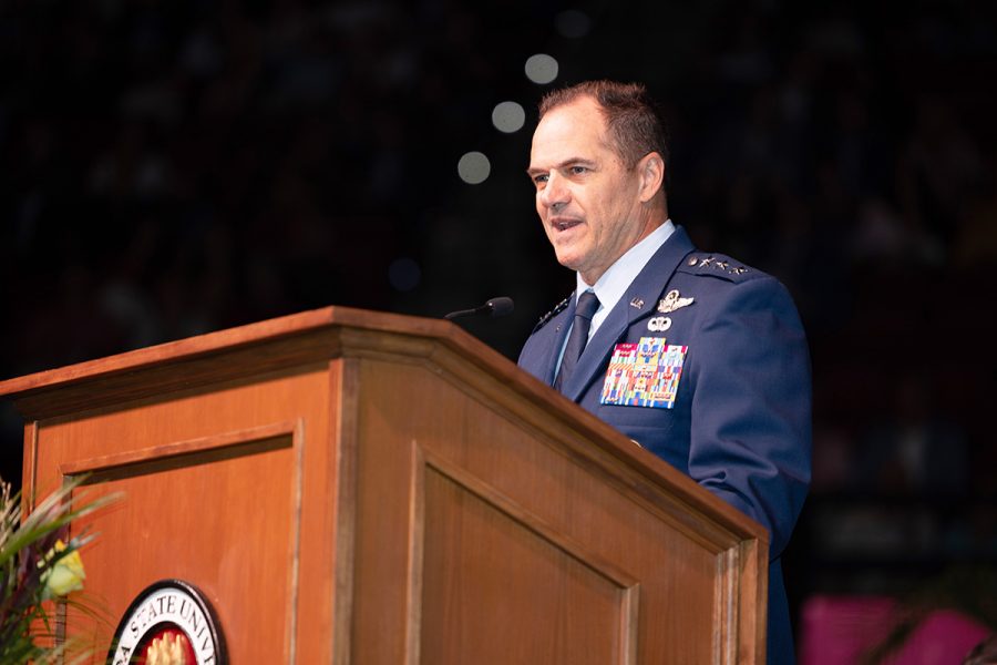 An Air Force general in full dress uniform speaks behind a wooden podium at a Florida State University event.