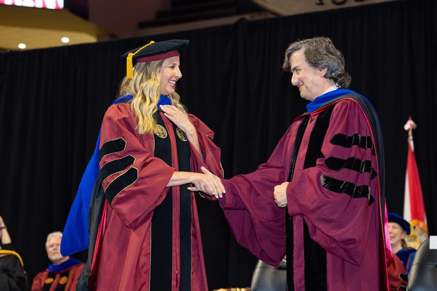 Provost Jim Clark congratulates Sara Blakely on her honorary degree during spring commencement.
