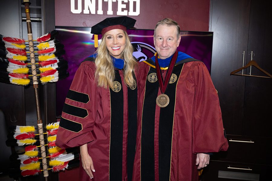 Sarah Blakely and President Richard McCullough pose together for a photo aat commencement.