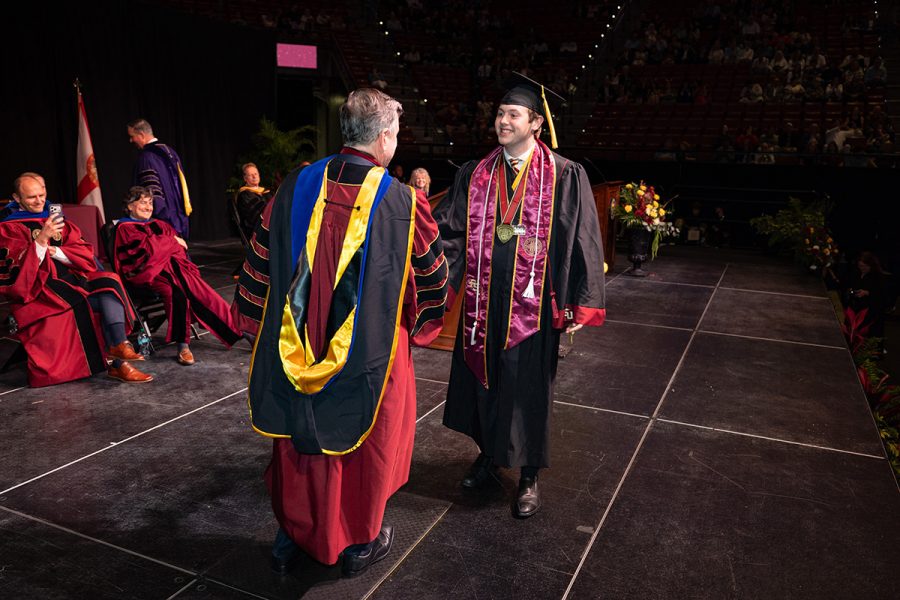 President Richard McCullough congratulates Student Body President Carson Dale on stage during Spring Commencement on May 2, 2026.