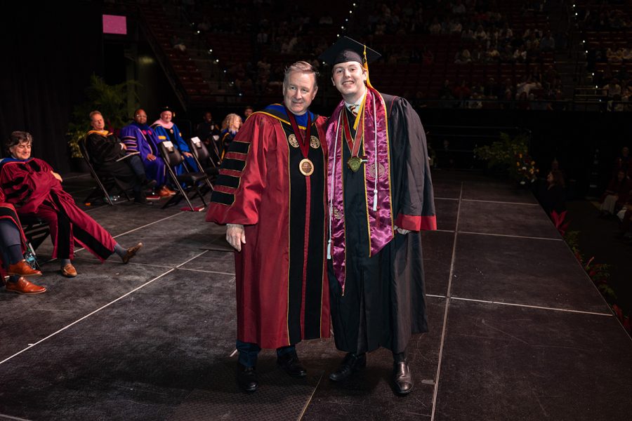 President Richard McCullough and Student Body President Carson Dale pose for a photo on stage during Spring Commencement on May 2, 2026.