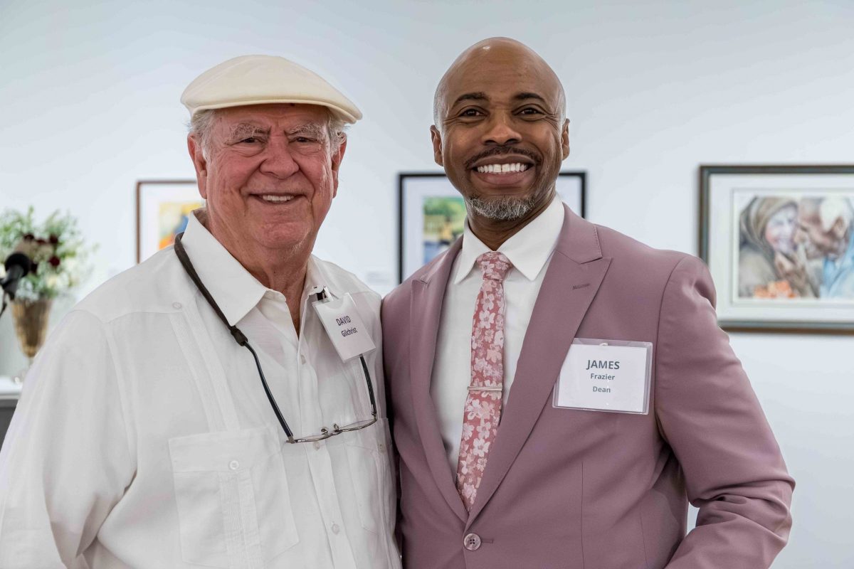 James Frazier smiles for a photo with a man during Art in Bloom.