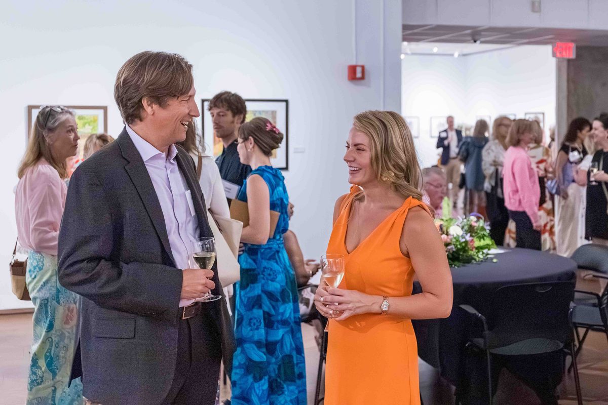 Two attendees chat during the Art in Bloom event.