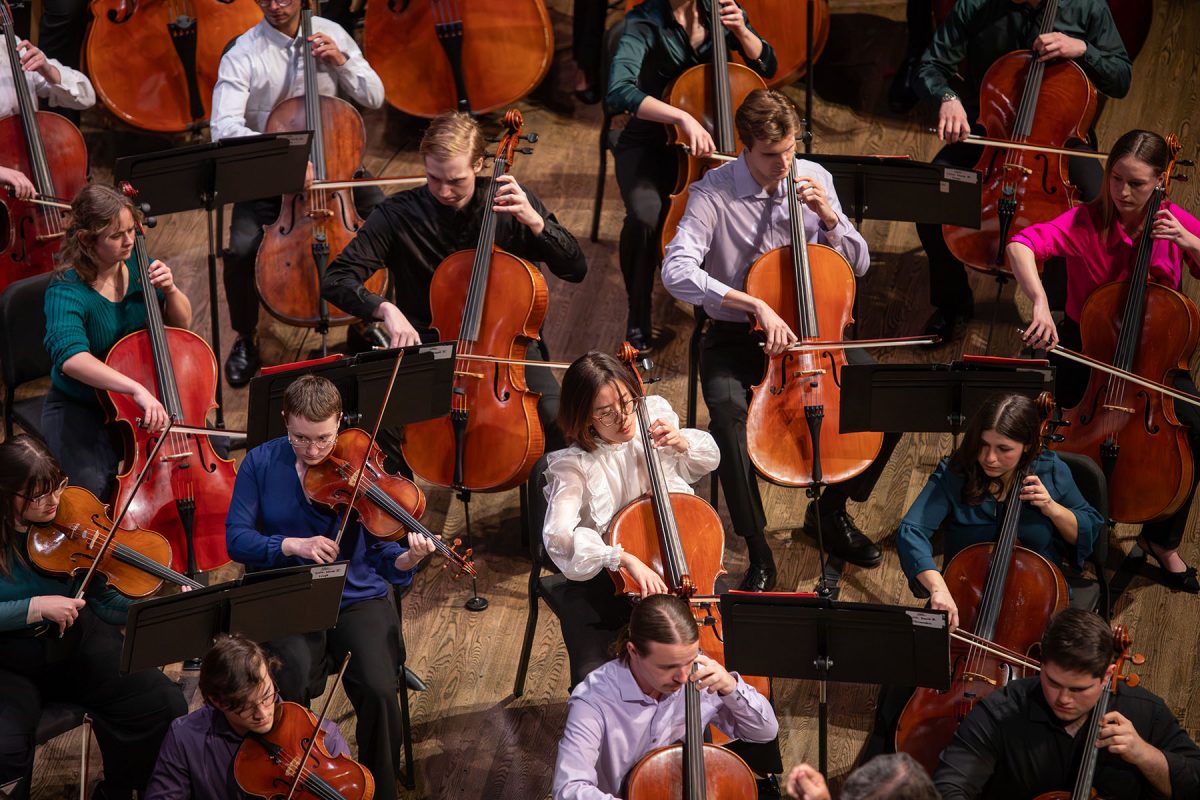 FSU musicians perform on stage during an orchestral concert, with string players seated throughout the ensemble.