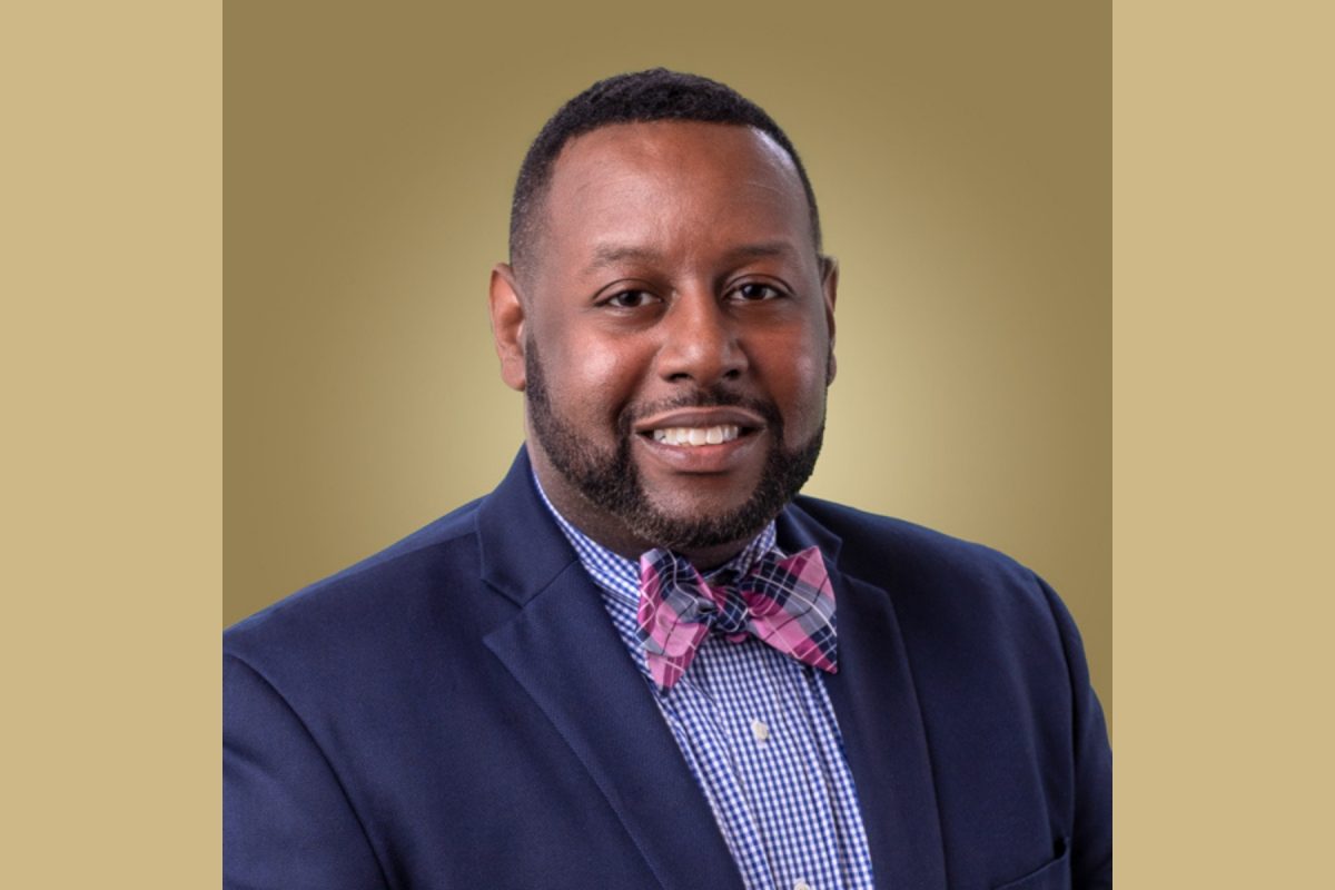 A headshot of Altony Lee against a gold background.