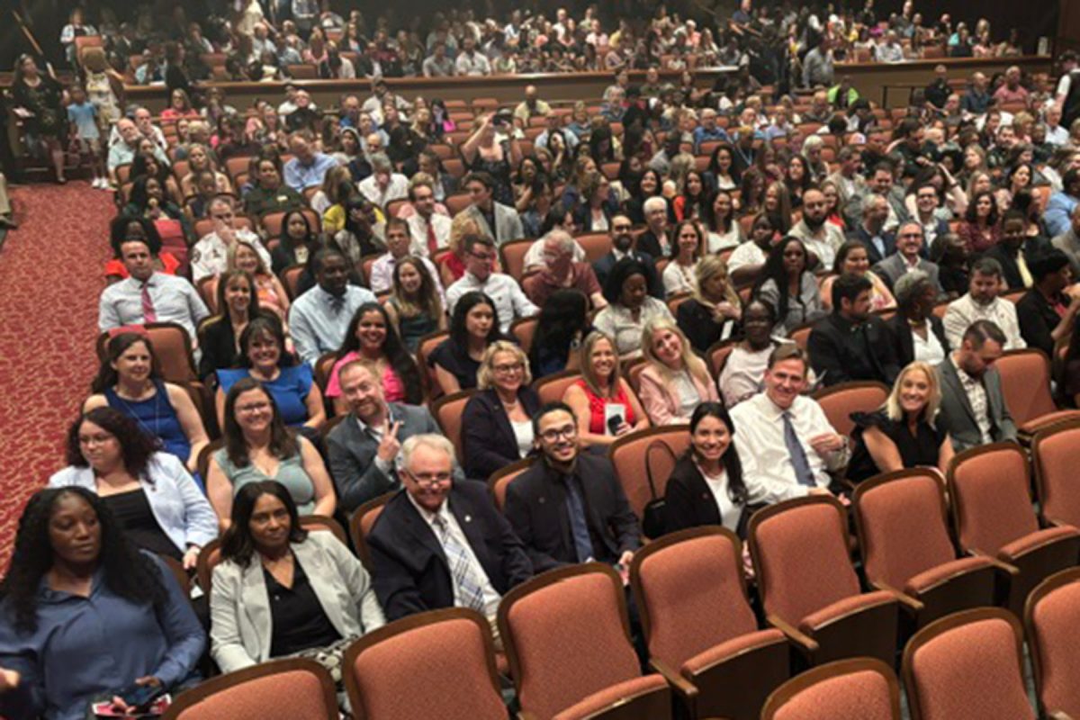 CPM graduates sit in Ruby Diamond Auditorium.
