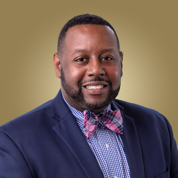 A headshot of Altony Lee against a gold background.