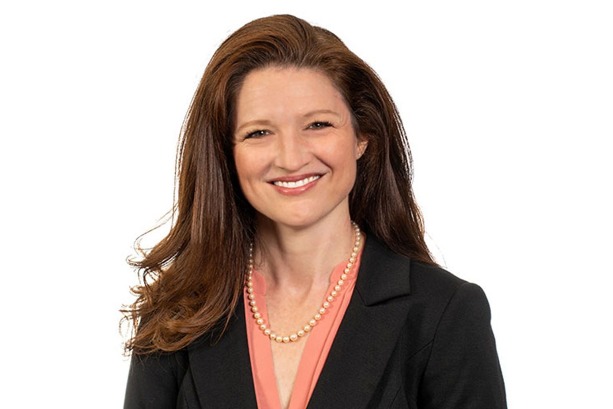 A headshot of Dawn Carr wearing a black suit jacket against a white background.