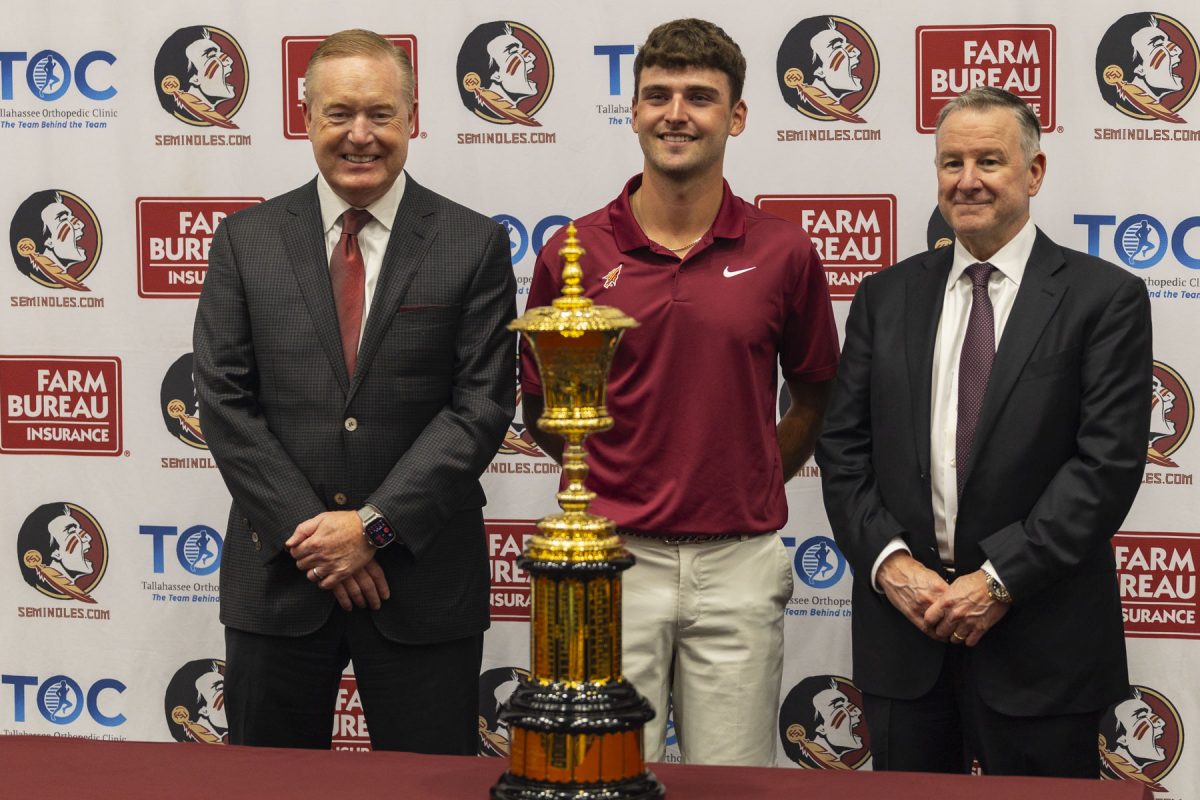 Jack Whaley, centert, with FSU athletic director Micheal Alford and FSU President Richard McCullough