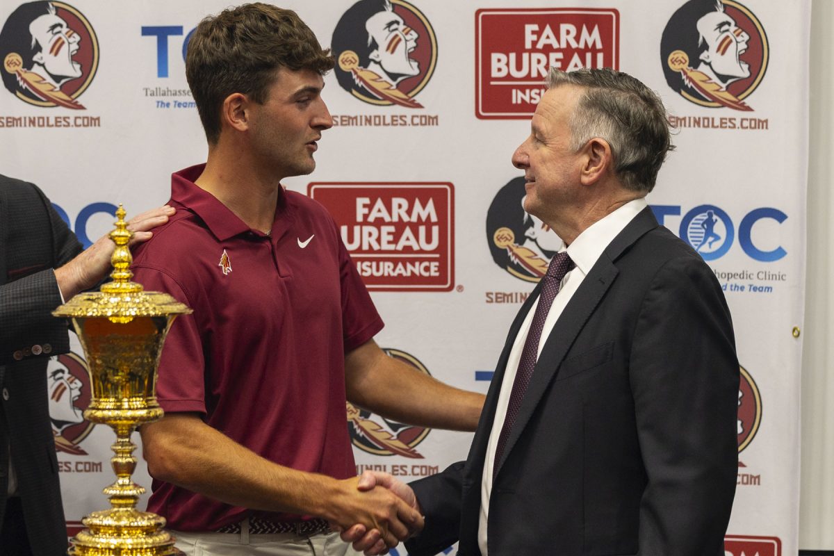 Jack Whaley shakes the hand of FSU President Richard McCullough