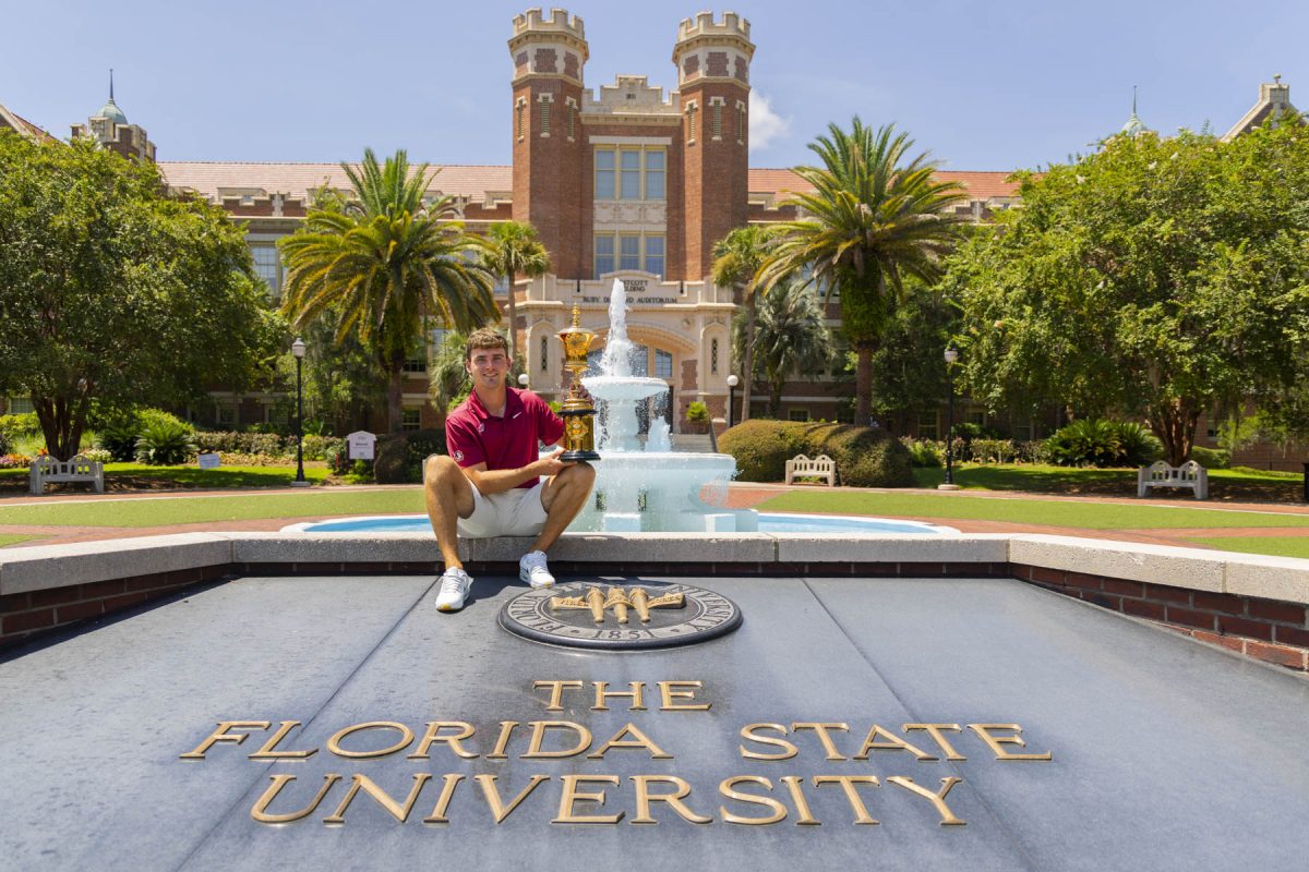 FSU Golfer Jack Whaley with the Havemeyer Trophy in front of the Westcott fountain