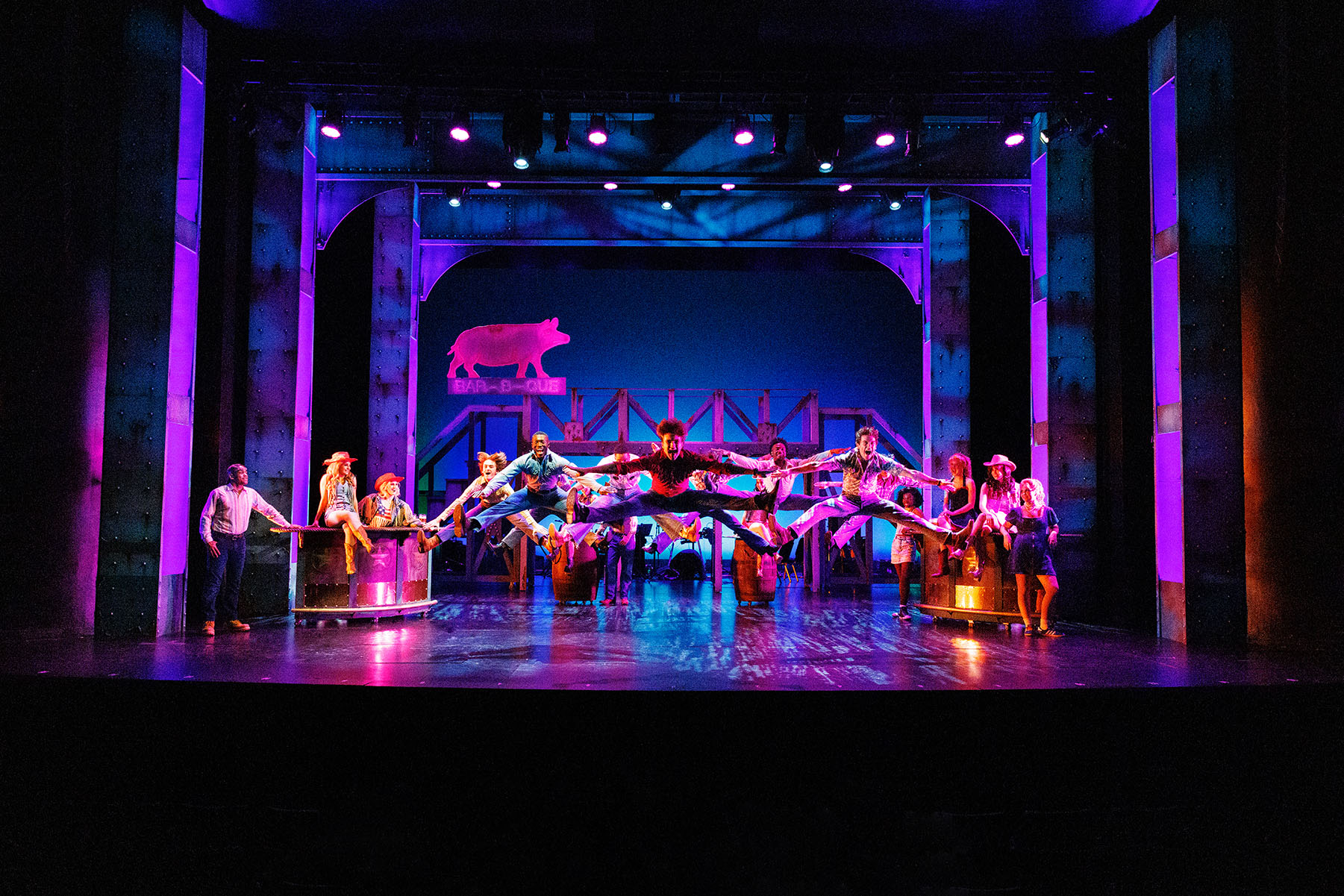Performers leap across the stage during the FSU School of Theatre’s colorful production of “Footloose.”
