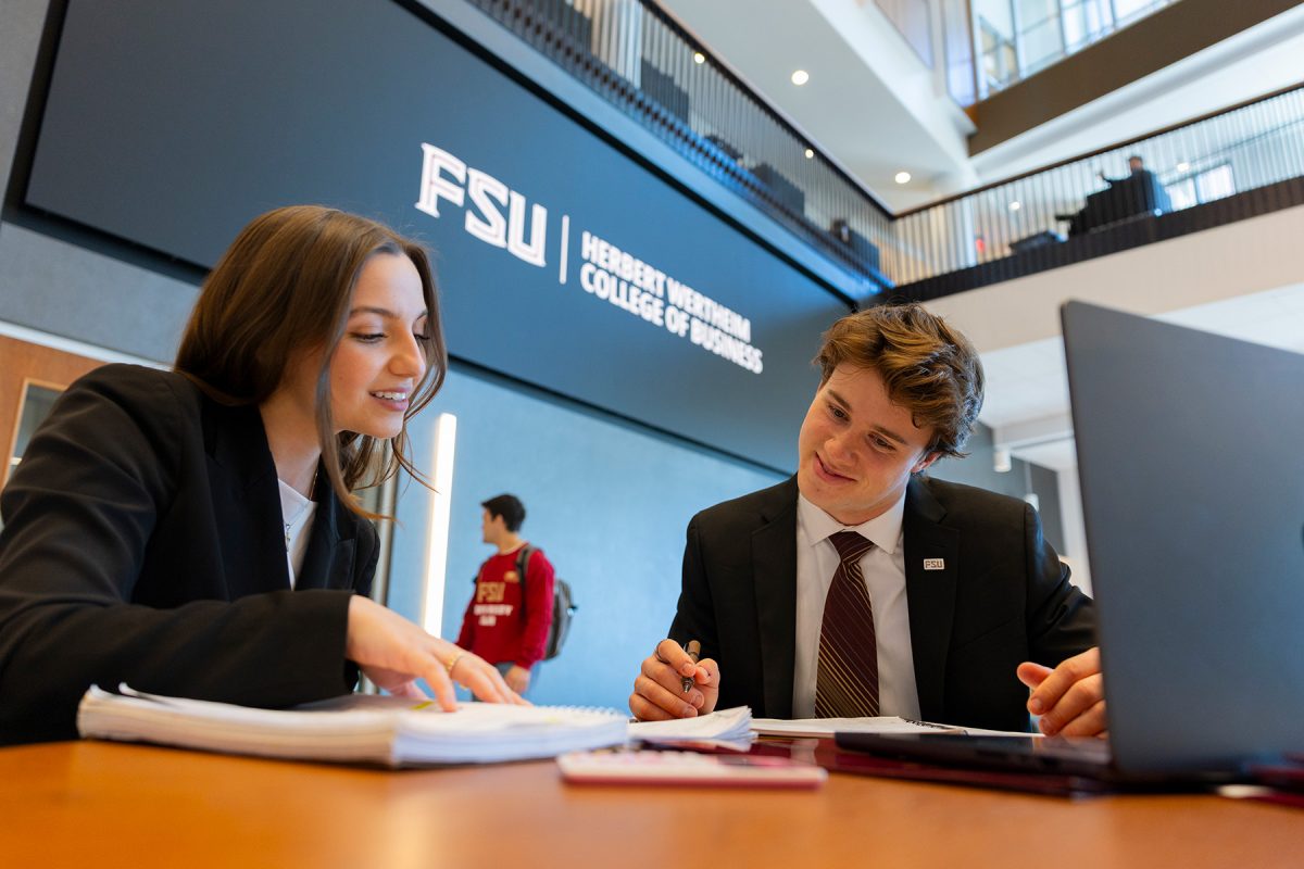 Two Florida State University Wertheim College of Business students studying.