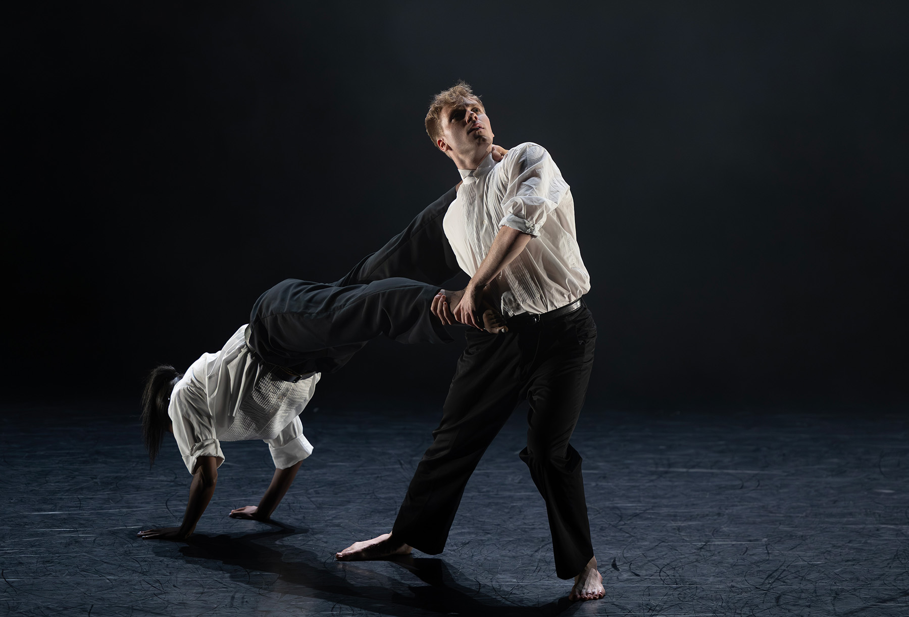 FSU School of Dance students Camille Pepper and Sam Hulkua perform “The One I Carry” onstage during the 2026 “Days of Dance,” with one dancer leaning backward as the other supports them.